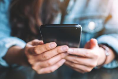 Close up of a woman holding a mobile phone