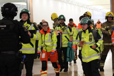 Police, fire, ambulance, and other emergency services during an exercise in a shopping centre.